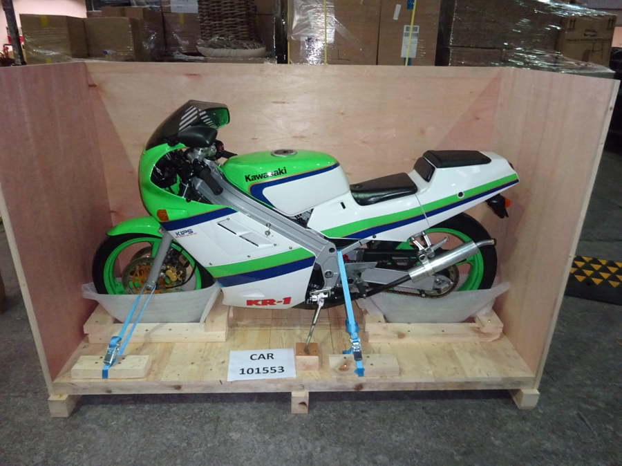Green and white Kawasaki KR-1 strapped into a wooden crate for shipping from Liverpool, UK, to Newark, USA, with Autoshippers.