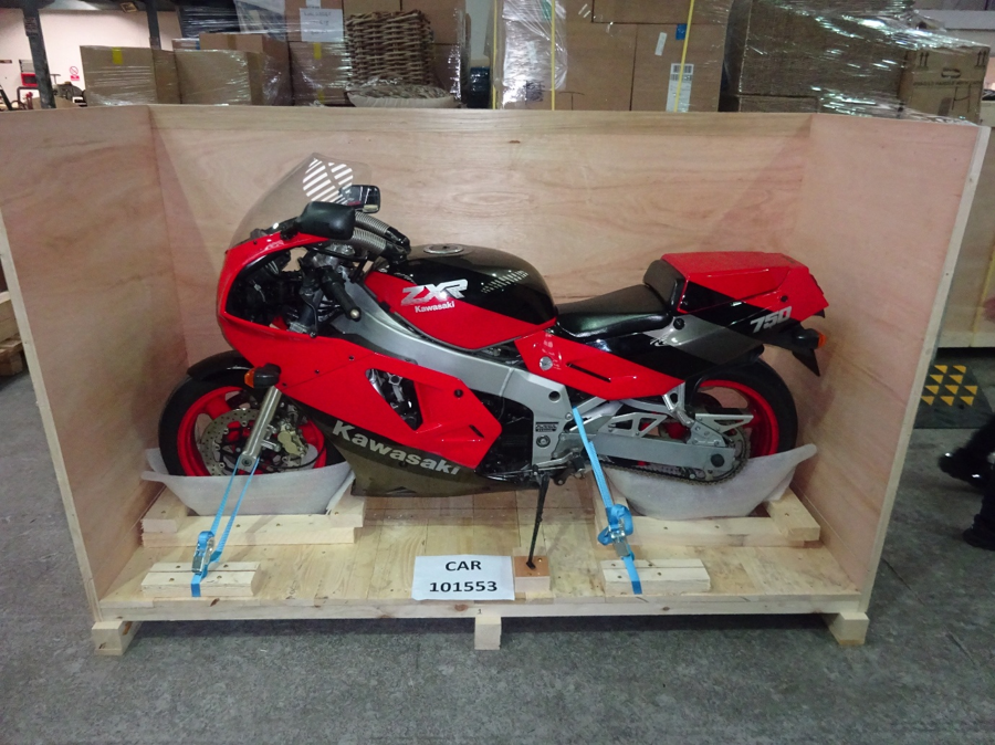 Red and black Kawasaki ZXR 750 secured in a wooden crate for shipping from Liverpool, UK, to Newark, USA, with Autoshippers.