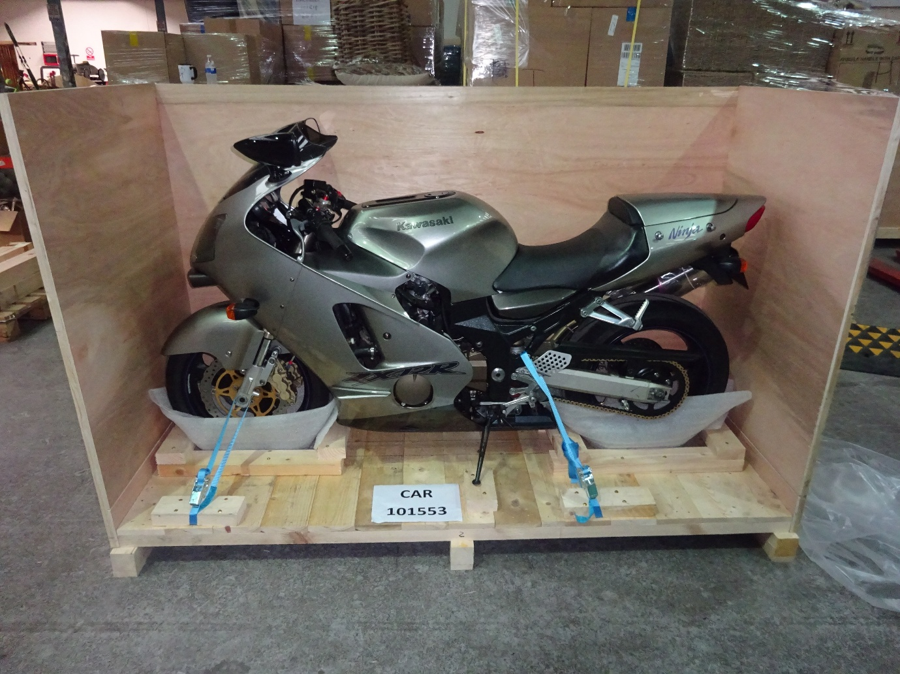 Silver Kawasaki ZX-12R secured with straps and padded wheel supports for shipping from Liverpool, UK, to Newark, USA, with Autoshippers.