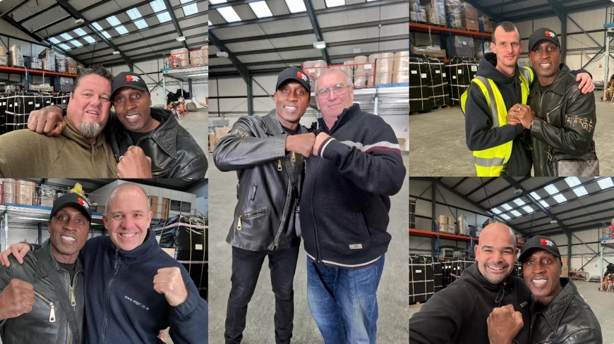 Nigel Benn posing for photographs with members of the AutoShippers team at the UK loading facility